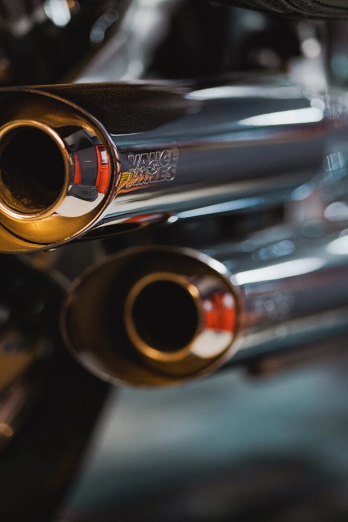 Detailed view of chrome motorcycle exhaust pipes with Vance & Hines branding.