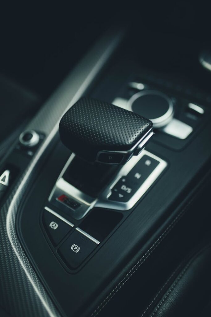 Close-up shot of a luxury car's gear shift with modern design elements.